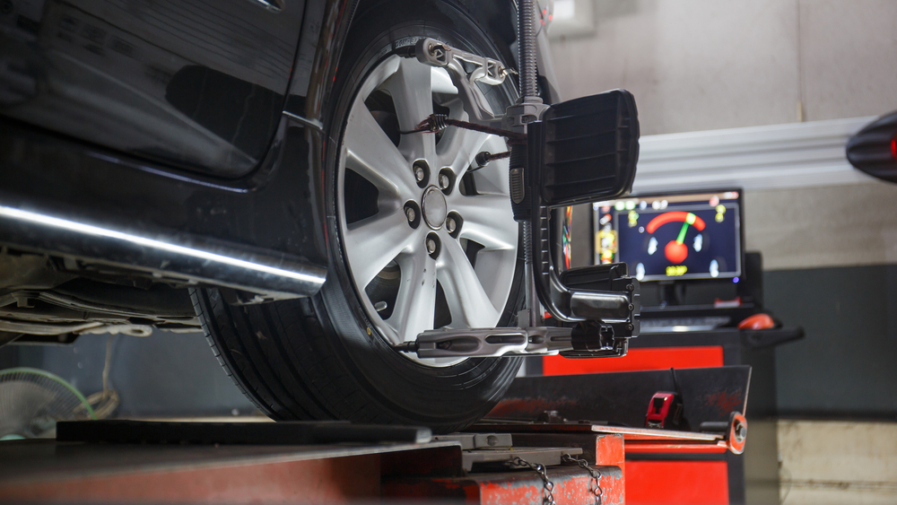 Car on a hoist with a wheel alignment rig fitted at Australia's Most Wanted Wheels and Tyres Bathurst
