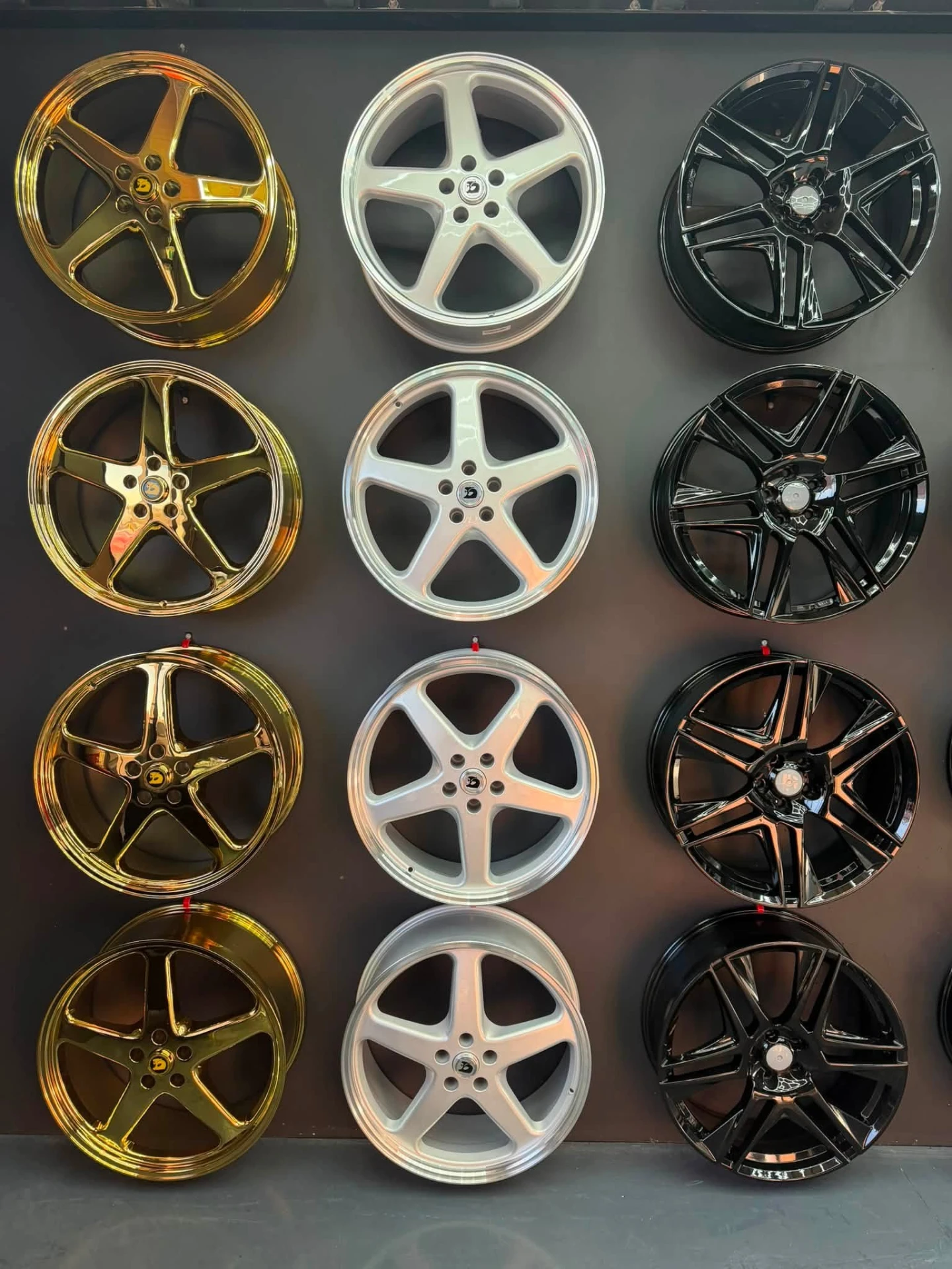 Display wall of gold, silver and black alloy wheels at Australia's Most Wanted Wheels and Tyres Bathurst