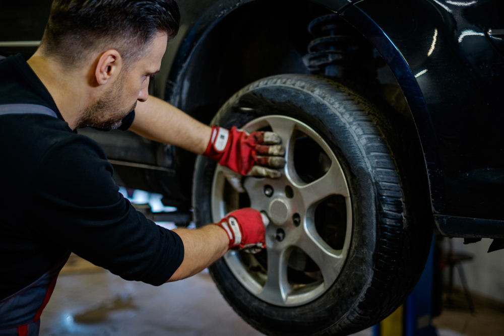 Mechanic removing an alloy wheel during a routine car service at Australia's Most Wanted Wheels and Tyres Bathurst